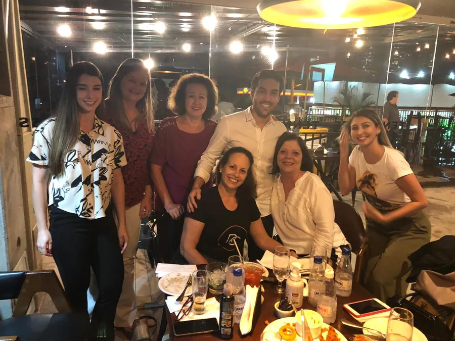 Alunos e professor reunidos em um jantar após o curso